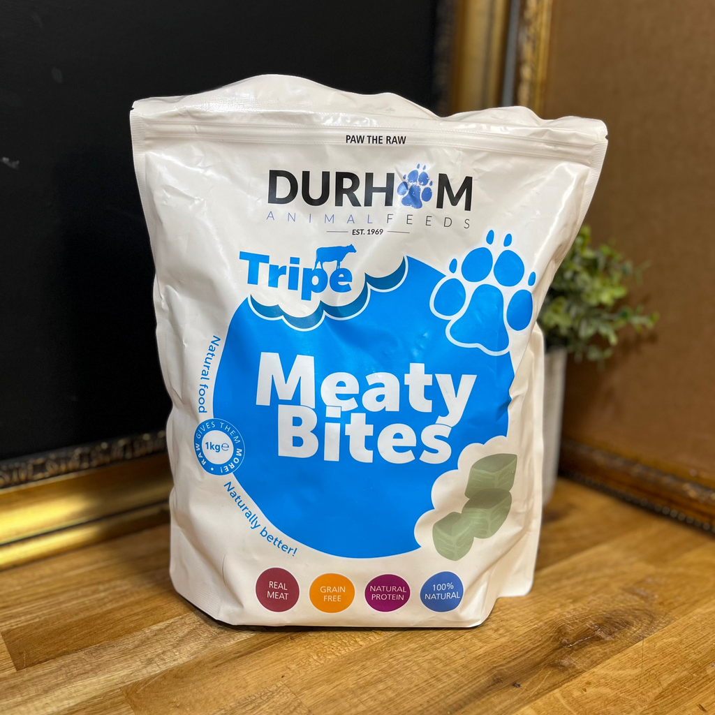 Bag of Durham Tripe Meaty Bites on a wooden surface with a dark background
